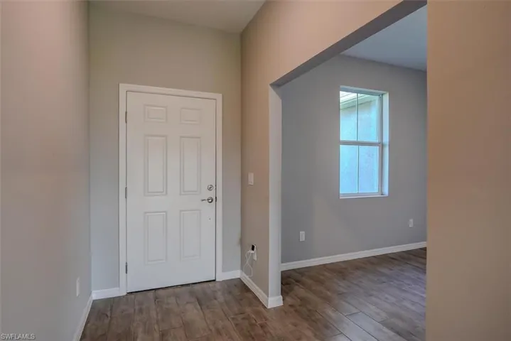 Den with wood-look tile floors