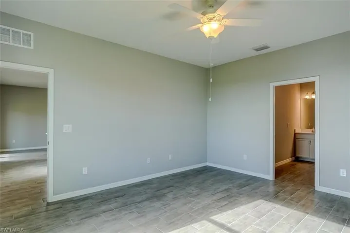 Empty room featuring ceiling fan and light hardwood / wood-style floors