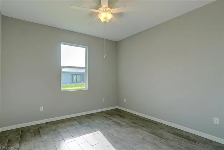 with ceiling fan and light wood-look style tile flooring