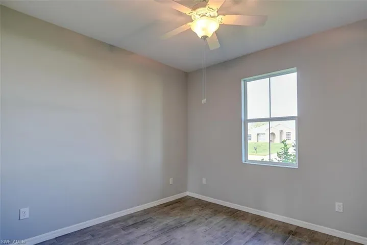 bedroom with ceiling fan and hardwood / wood-style floors