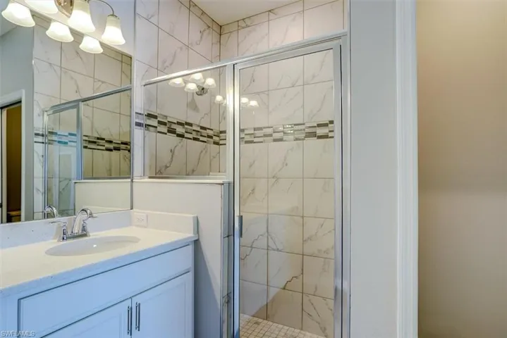 Bathroom with vanity and an enclosed shower