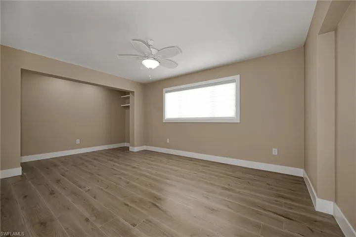 Spare room featuring wood finished floors and ceiling fan