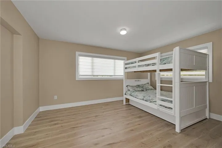 Bedroom with baseboards and light wood finished floors