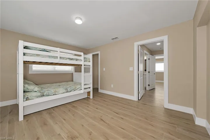 Bedroom with baseboards and light wood-style flooring