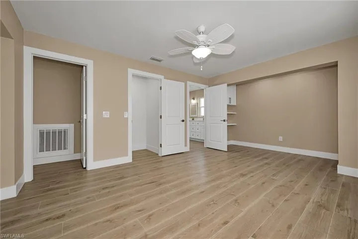 Unfurnished bedroom featuring light wood-style floors and ceiling fan