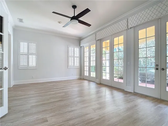 Unfurnished room featuring ceiling fan, ornamental molding, and light hardwood / wood-style floors