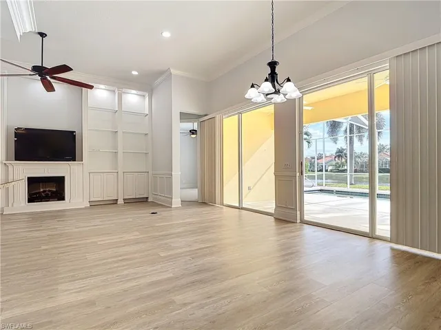 Unfurnished living room with crown molding, ceiling fan, and light hardwood / wood-style flooring