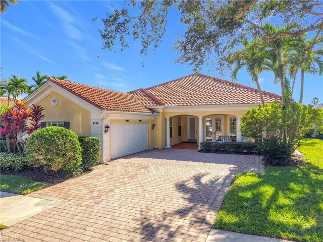 Mediterranean / spanish-style home featuring a porch and a garage