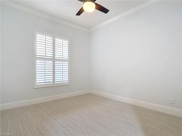Empty room with ceiling fan and ornamental molding