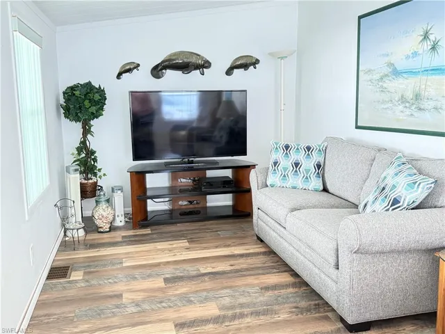 Living area with wood finished floors and baseboards