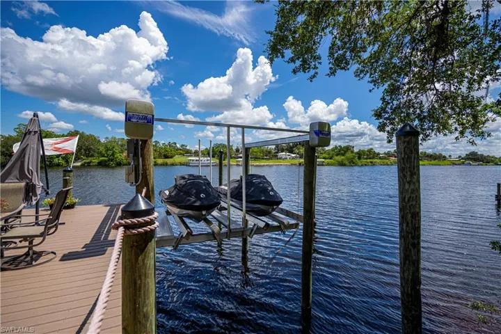 Dock area featuring boat lift and a water view