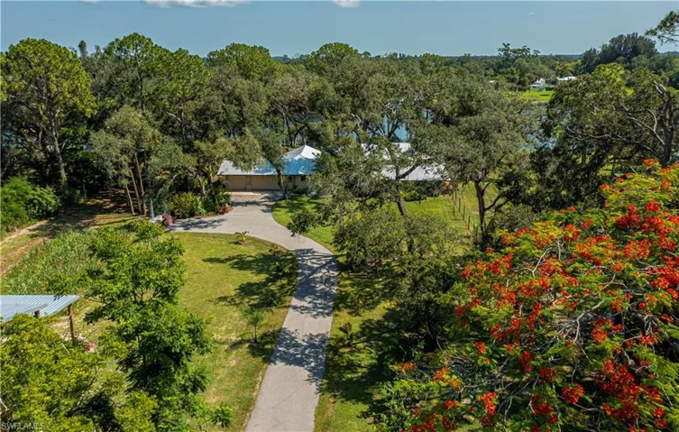 Aerial view of property and surrounding area featuring a heavily wooded area