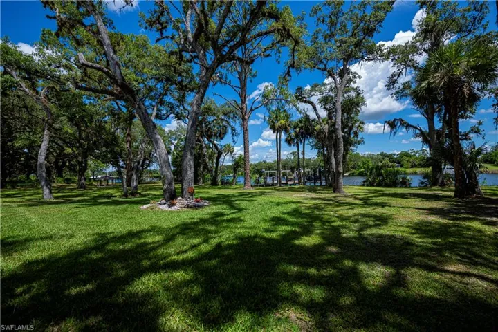 View of green lawn with a water view