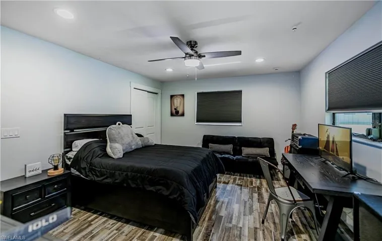 Bedroom featuring wood finished floors, recessed lighting, ceiling fan, and a closet