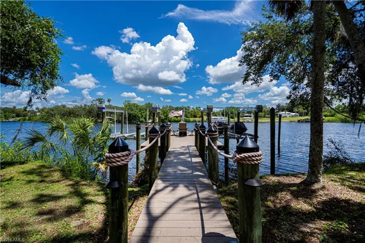 Dock area featuring boat lift and a water view