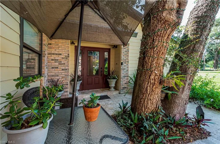 Property entrance with brick siding and french doors
