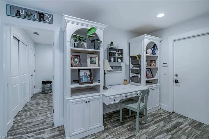 Office space featuring wood finished floors and recessed lighting