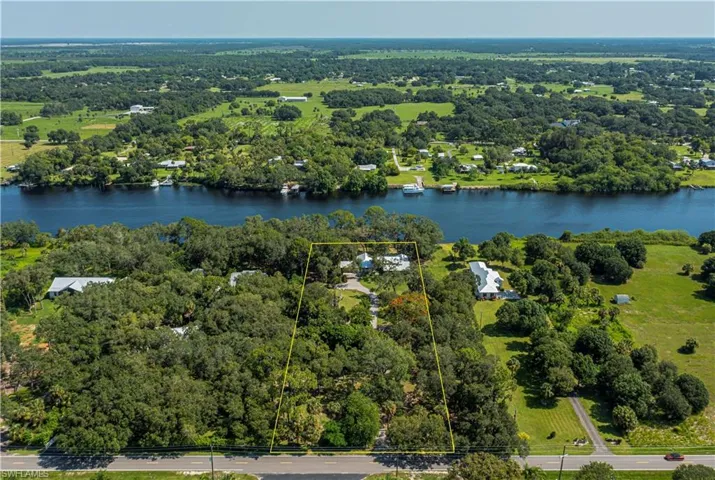 Aerial view of property's location featuring a large body of water and property parcel outlined