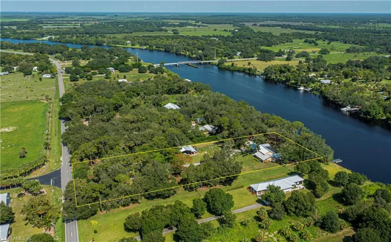 Aerial view of property's location with a large body of water and property boundaries highlighted