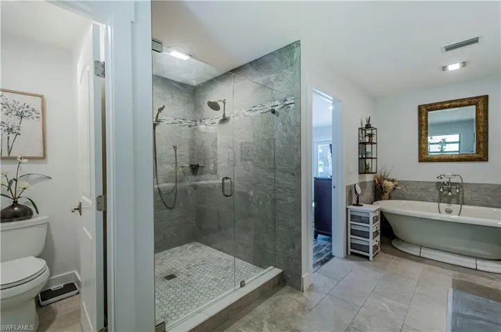 Bathroom with a soaking tub and a stall shower