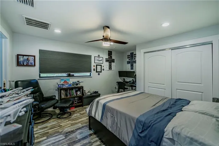 Bedroom with wood finished floors, recessed lighting, a closet, and ceiling fan