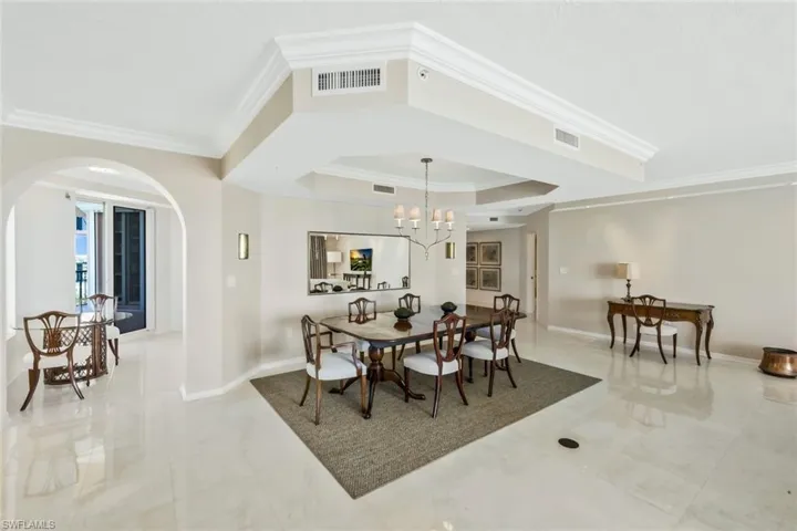 Dining room featuring ornamental molding and a tray ceiling