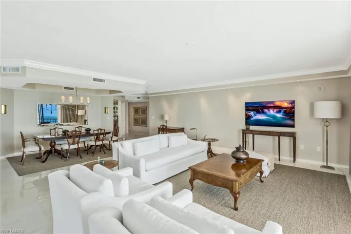 Large living room with views of beach and water