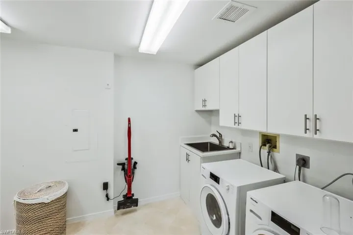 Laundry area with cabinet space and upgraded washer and dryer