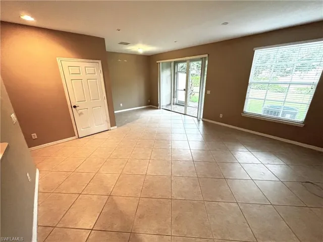 Empty room featuring light tile patterned flooring and recessed lighting