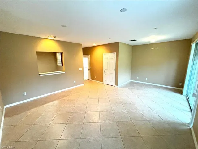 Unfurnished room featuring baseboards and light tile patterned floors