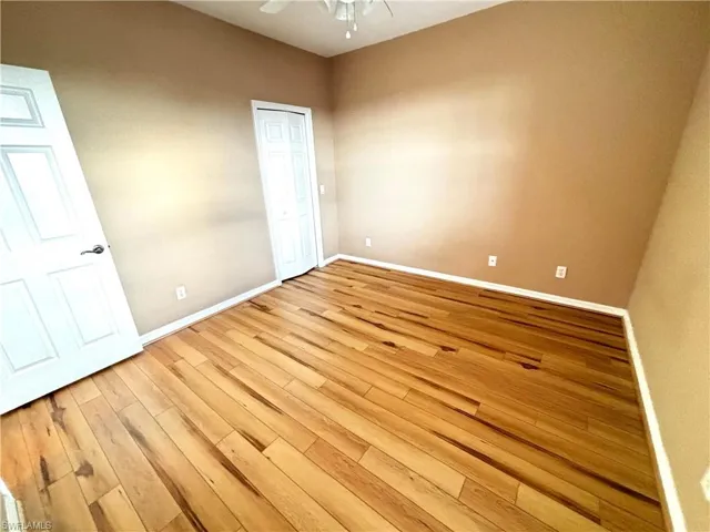 Empty room featuring light wood-style floors and a ceiling fan