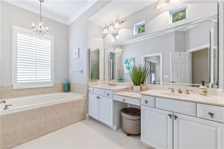 Main bathroom with separate tub and two sinks.