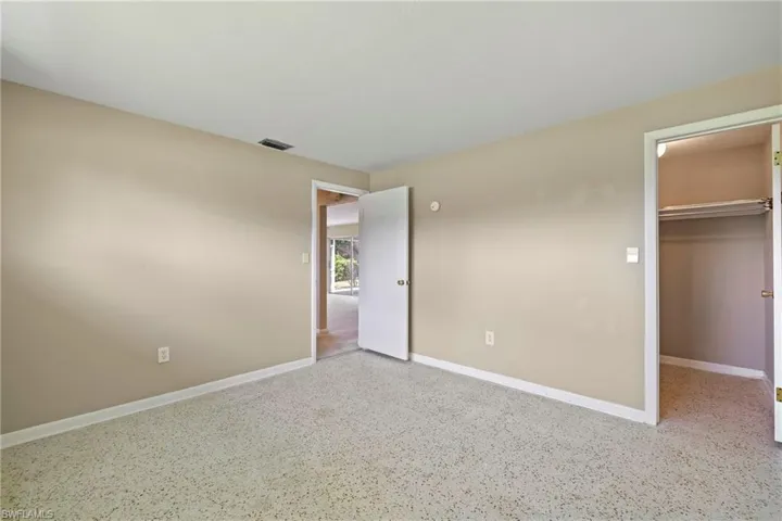 Unfurnished bedroom featuring a closet and a spacious closet