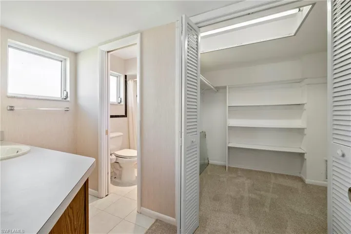 Bathroom featuring tile patterned flooring, vanity, and toilet