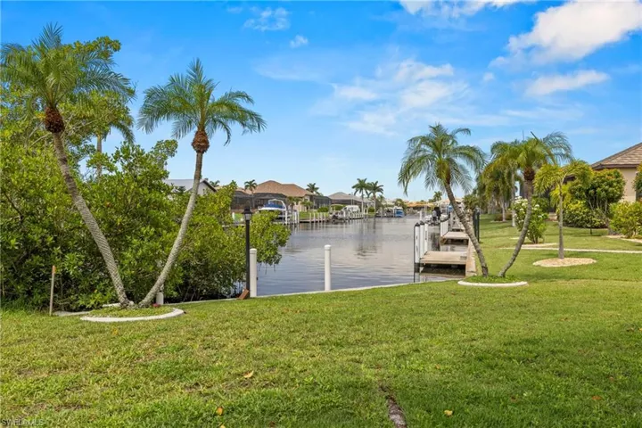 Dock area featuring a water view and a yard