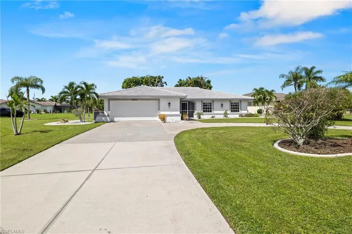 Ranch-style house with a garage and a front yard