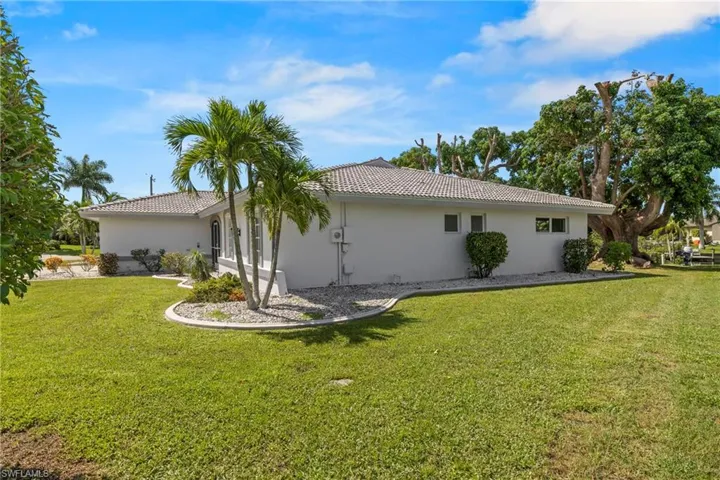 View of side of property featuring a yard