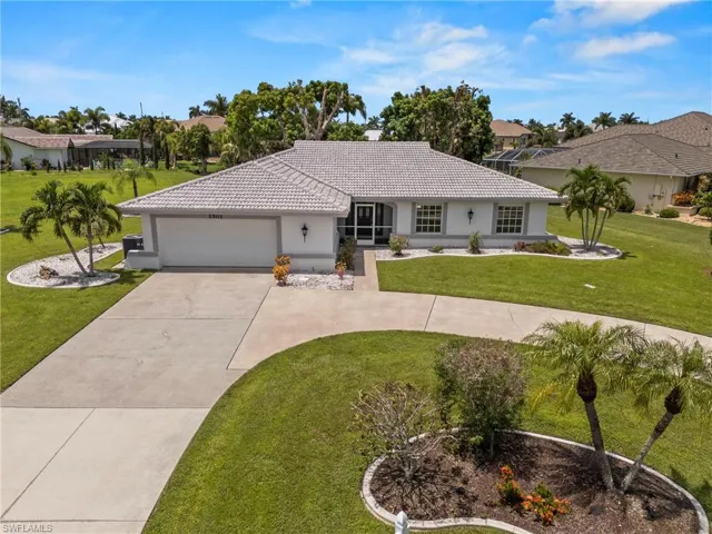 Single story home featuring a garage and a front lawn