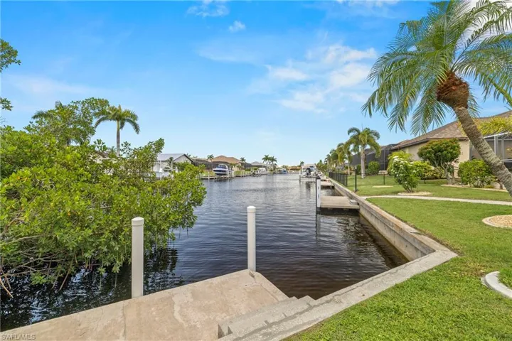 Dock area featuring a yard and a water view