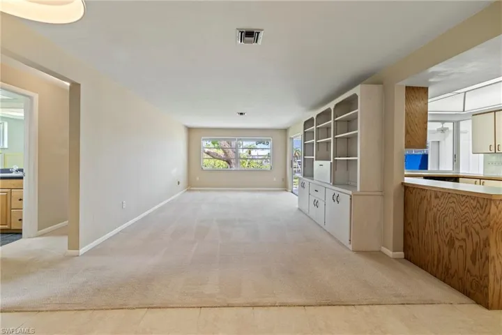 Unfurnished living room with light colored carpet