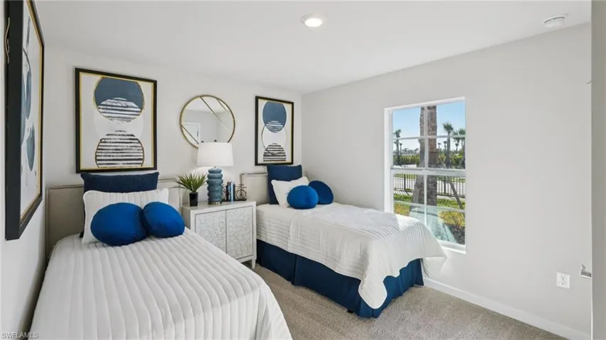 Bedroom featuring light gray wall paint, a window with exterior landscaping visible, recessed lighting, and soft carpet flooring