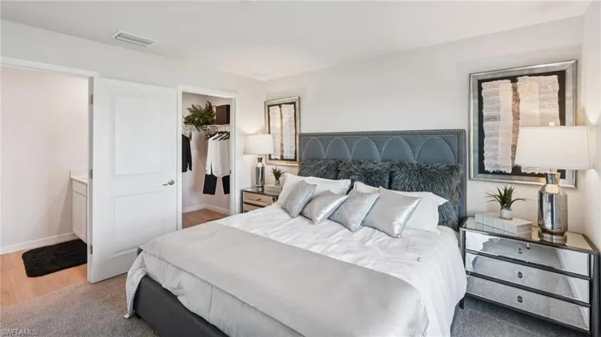 Bedroom featuring light wood-finish flooring and light gray carpeting