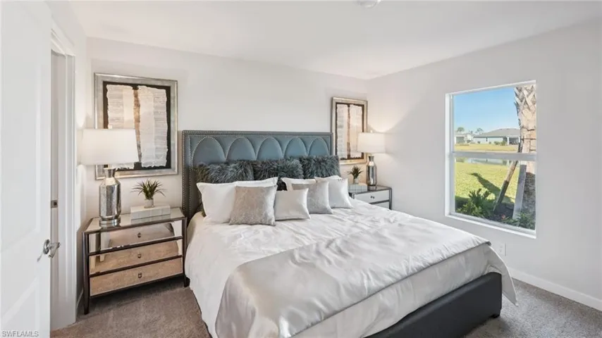 Bedroom featuring a large window, light gray carpeting, and white painted walls