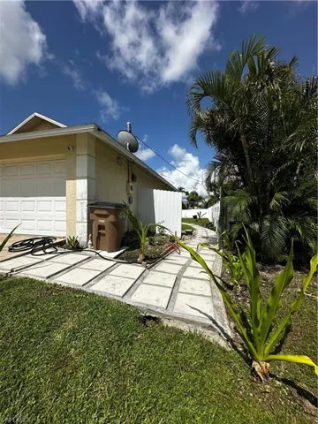 View of property exterior with an attached garage