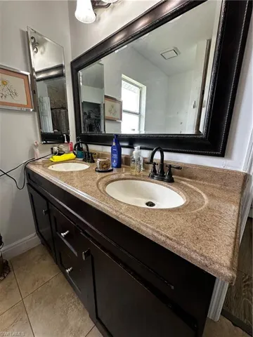 Full bathroom featuring double vanity and tile patterned floors