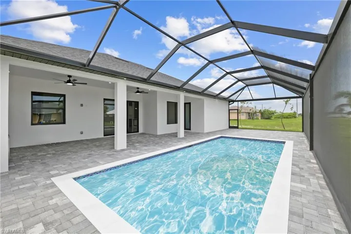Swimming pool featuring a ceiling fan, a patio, and a lanai