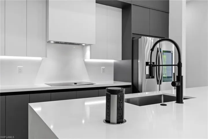 Kitchen with modern cabinets and black electric stovetop