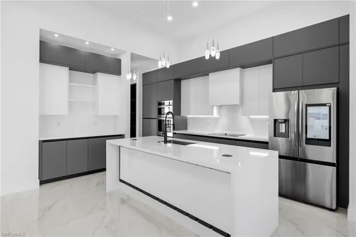 Kitchen with appliances with stainless steel finishes, open shelves, modern cabinets, and recessed lighting