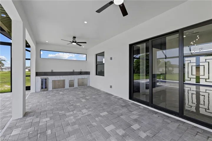 View of patio / terrace featuring a ceiling fan, an outdoor kitchen, and wine cooler