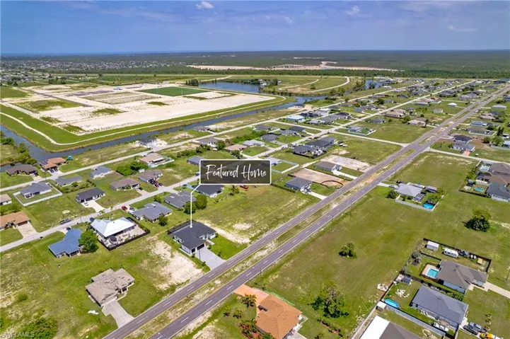 Aerial view of property's location with a large body of water and nearby suburban area